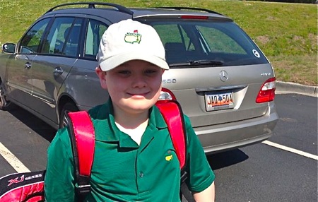 active boy standing near family van