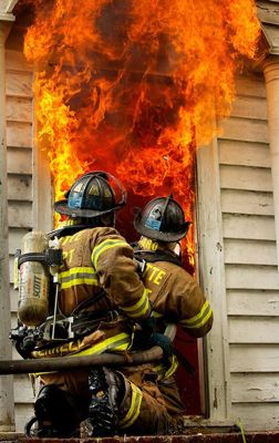 two firefighters working on a blaze