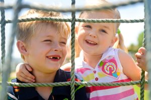 children climbing on a playground net